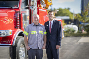 Rob Carey stands with Nathan Buckler of Buckler's Towing Service at his Mashpee space.