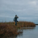 Man fishing on a marsh